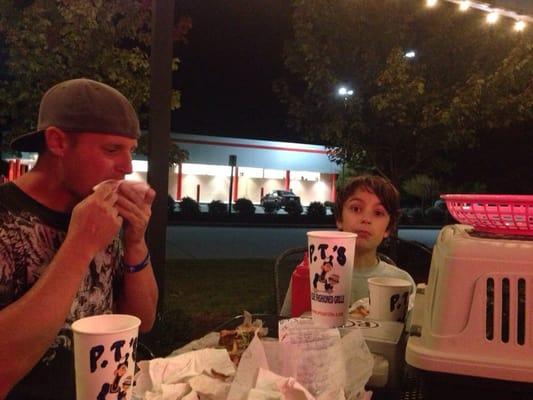 Eating our burgers and fries. Enjoying the weather on this cool evening.