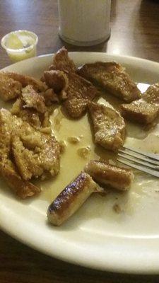 French toast almost gone bathed in syrup and butter,sausage links cooked perfect.