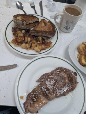 Steak and eggs, and marble rye toast with potatoes..