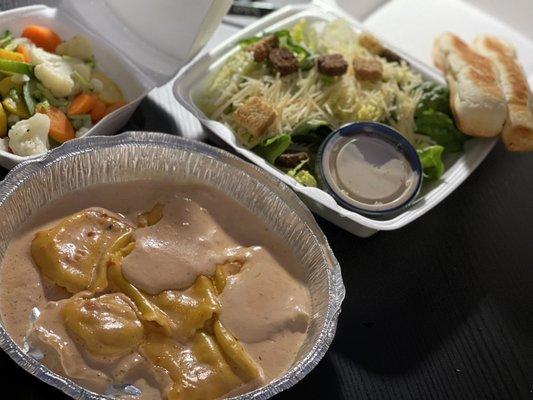 Lobster ravioli, steamed veggies, and Caesar salad w/breadsticks