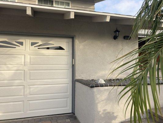 Restucco of the planter and garage door painted.