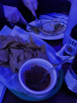 Homemade chips and salsa - with a chicken cheesesteak in the background.