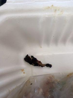 Piece of burnt chicken.