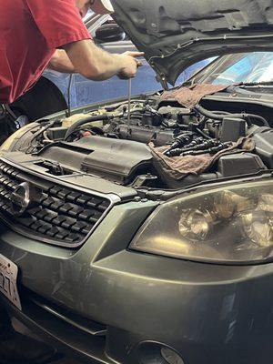 Greg working on my car.