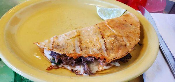 Quesa-birria taco. I ate the onion and seasoned radish before the photo opp. The best, most flavourful and tender beef I've ever had.