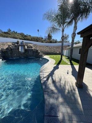 Some pavers and artificial grass around a  recently updated pool. Finished off the yard nicely!!