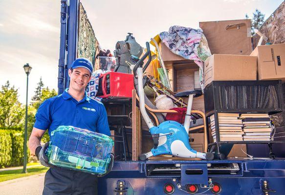 1-800-GOT-JUNK? team with a loaded junk truck after completing the job