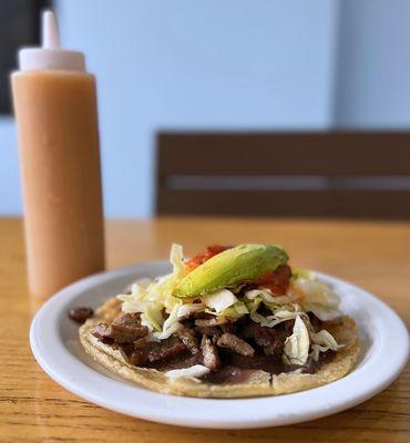 Pork Sabultes: Fried tortilla puff w/ grilled pork, onions, red salsa, cabbage, avocado | $4.50