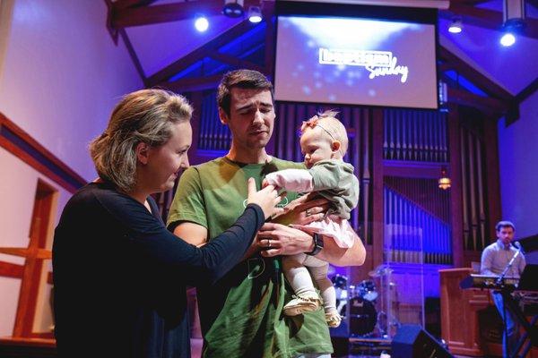 Pastor Connor Guerzini praying during a baptism service at our Lifehouse Forest Park Campus.