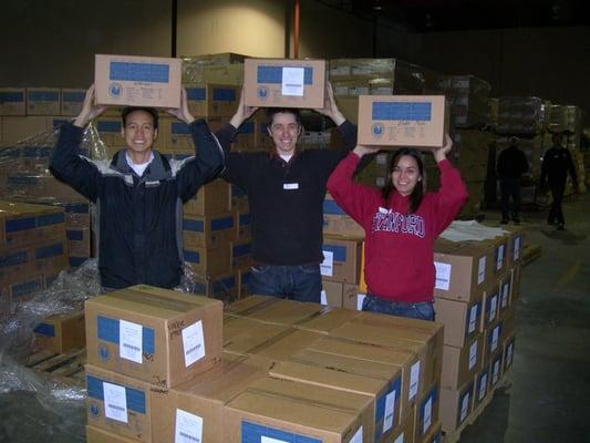 Happy volunteers help MedShare prepare a shipment