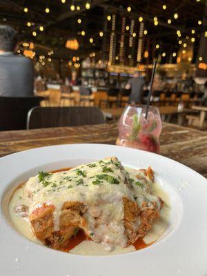 Lasagna and a virgin drink with lime