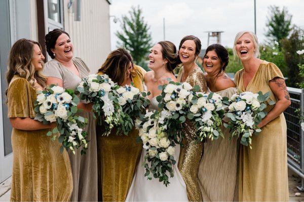 My bridesmaids and I sharing a laugh, but honestly... those BOUQUETS!!