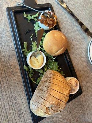 Warm sourdough bread with three compound butters.