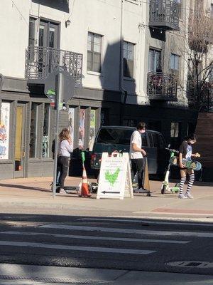 Two kids walking out of the sk8 shop with all new gear