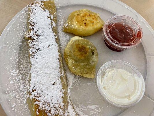 Part of the Polish combination plate: cheese crepe and perogies.