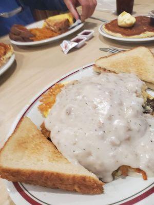 Hashbrowns smothered with sausage gravy, and  bacon