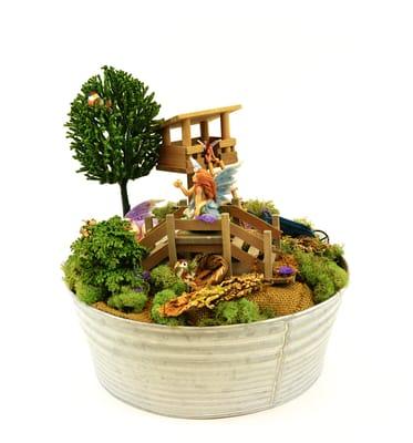 Tin containers make excellent fairy gardens. We sell all of these components to create your own!