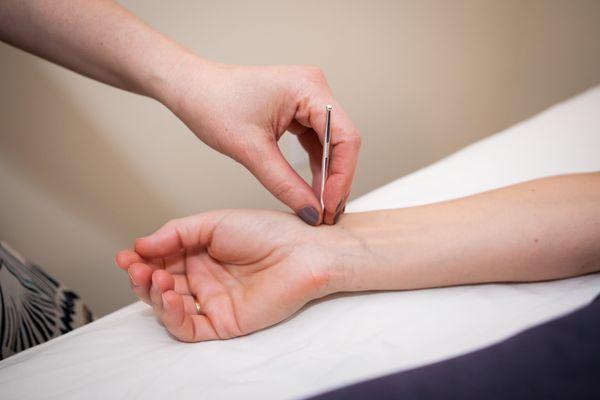 Using the "teishin" one of the gentle needle-alternative tools of Japanese style acupuncture.