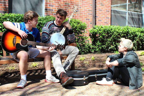 Students work out a song in the courtyard.