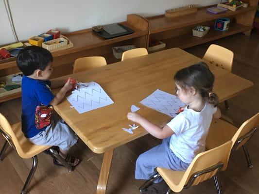 Children at our Great Valley School practice cutting lines whilst  improving their fine motor skills