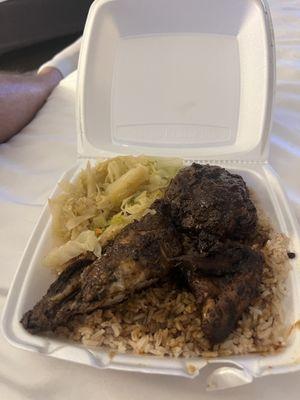 Jerk chicken, rice, and cooked cabbage + carrots.