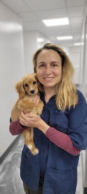 Dr Annie sneaking in some cuddles with a new pup.