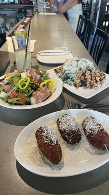 antipasto salad, arancini risotto balls, peach arugula salad