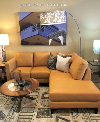 The Kendall sectional in butterscotch leather by American Leather. The Unity coffee table by Lyndon.