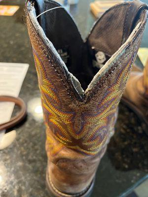 Leather "liner" that she installed is not cut to match the shape of the boot and glue ended up on the outside of the boot