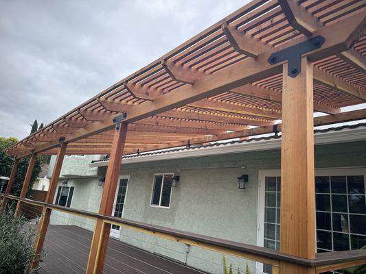 Composite deck with wire rails and wooden pergola