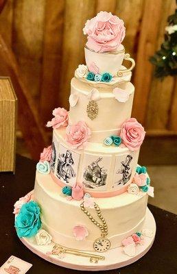 3 tiered Alice in Wonderland themed wedding cake with edible photos, sugar flowers and edible teacup topper.