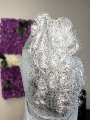 Embracing the beauty of graying hair with vibrant, age-defying color and style.