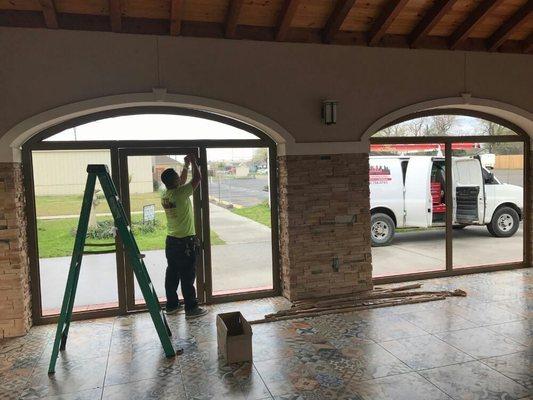 Our A Team installing storefront windows and doors @ Nuestra Parroquia San Felipe. Call us at 281-714-0745 for a free estimate.