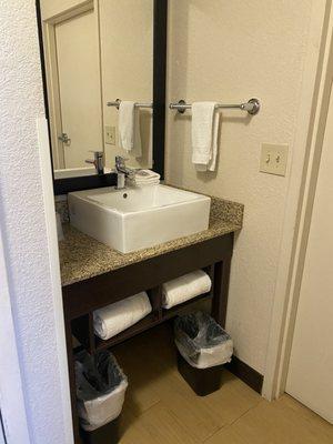 Sink and towels outside shower & toilet room