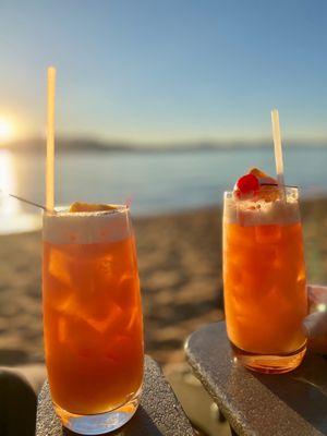 Guava Mai Tais on the lake shore during sunset