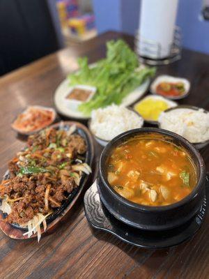 Spicy Pork Bulgogi Dinner Plate, tofu stew, rice, lettuce and traditional Korean sides