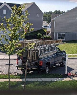 Workers unloading completely on lawn of finished unit.