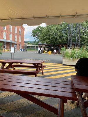 See that sandwich shop? Get a beer near by or wait in the tent area for your food.