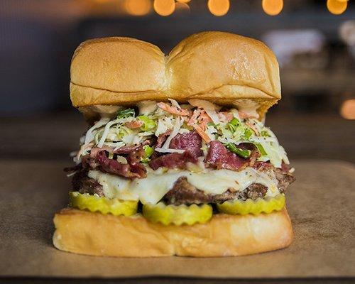 THE MENSCH - white american cheese, pickles, pastrami, haus slaw, 1001 island