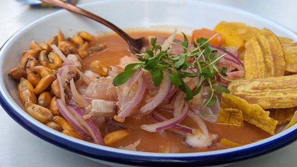 Ceviche Mixto (snapper, shrimp, octopus), with plantain chips, red onion, sea island red peas, and sweet potato as accompaniments