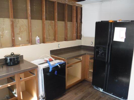 Pre-Construction - This kitchen suffered a fire and had to have the upper cabinets and drywall removed.