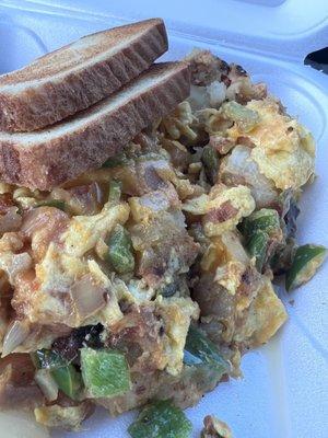 Scramble with potatoes, eggs, green bell peppers, onions, tomatoes and cheese