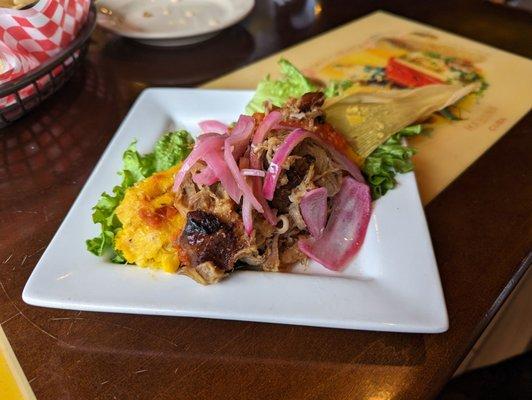 A Tamale with Pork and pickled red onions