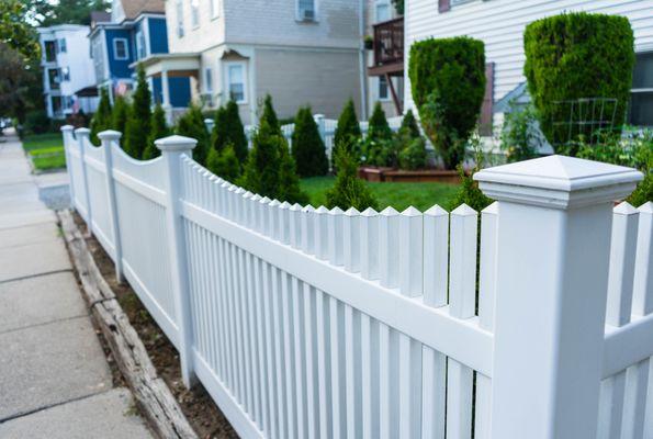 White fence with decorative posts and pickets.