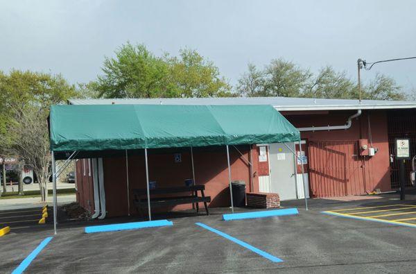 Preparing for the summer heat/rain with a canopy out back for the smoking contingent! Can you say hurricane magnet!