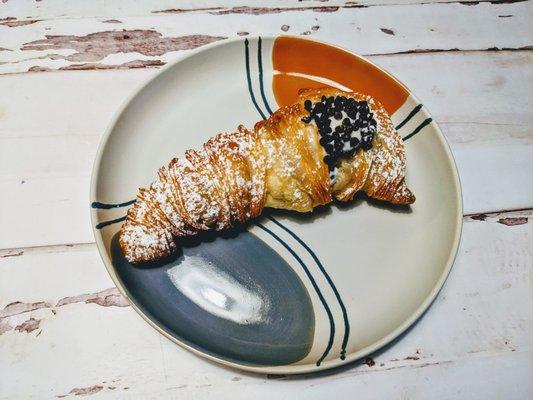 Lobster tail pastry filled with ricotta cream and encrusted with chocolate chips.