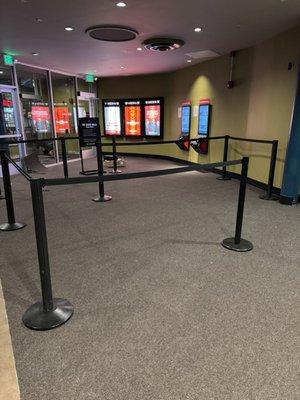 Carpet tile installation in the entrance and waiting area of a moving theater