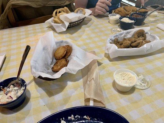 Fried green potatoes, fried mushrooms, coleslaw and onion rings.