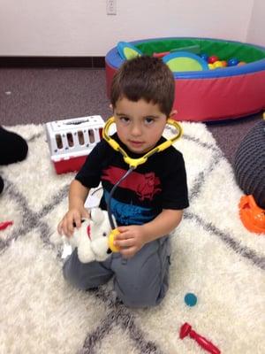 The cutest vet we've ever seen! Having fun playing with the pet vet set and saying "big kid words" like "puppy" and "nose."