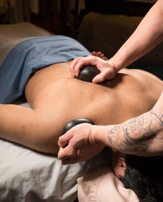 Our Hot Stone Massage is deeply relaxing AND therapeutic. We use the stones to heat our hands, your tissue, and to dig in to remove stress.